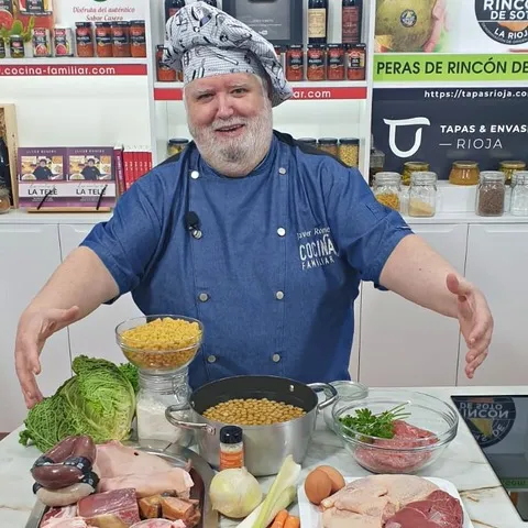 Chef Javier Romero with fresh ingredients for a Spanish stew in the TV studio
